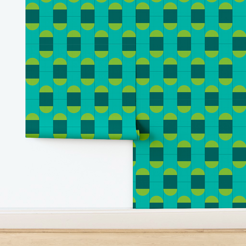 The artwork features a repeating geometric pattern of symmetrical shapes resembling elongated, curved diamonds or petals in various shades of blue and green. Each shape is split vertically with one half filled with a light blue and the other half filled with green or darker blue. The background is a light, almost pastel blue, which provides a soft yet vibrant backdrop. One of the blue shapes near the upper left contains a white starburst element, adding a focal point of brightness to the composition. The overall design conveys a modern, mid-century aesthetic with clean lines and harmonious color contrasts.
